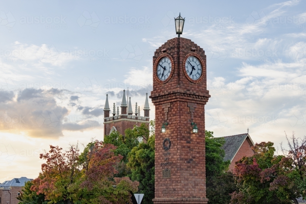 The iconic clock tower in the middle of roundabout at Mudgee with Church in background - Australian Stock Image