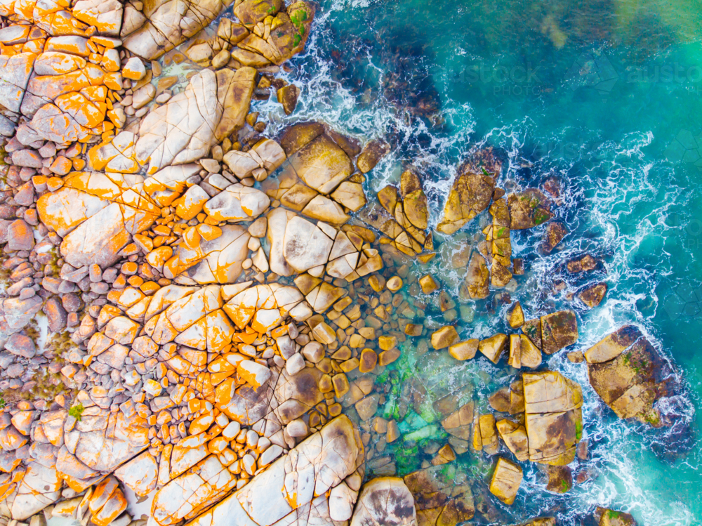 The iconic lichen covered rocks and turquois ocean water in the Bay of Fires. - Australian Stock Image