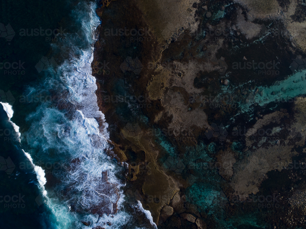 The ocean moves turbulently near a still reef area - Australian Stock Image