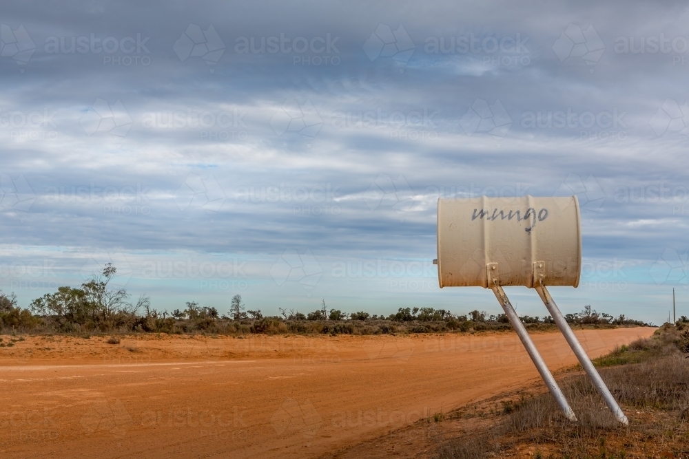 The road and signage at Mungo National Park in the NSW outback desolate desert landscape - Australian Stock Image