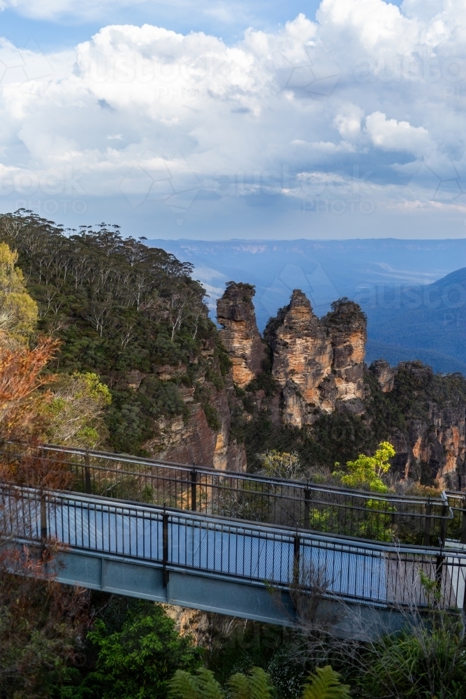 The Three Sisters iconic rock structures seen from Echo Point with viewing bridge in foreground - Australian Stock Image