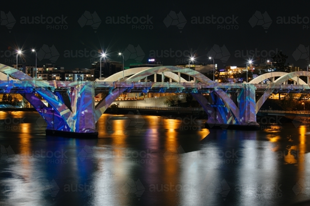 The William Jolly Bridge illuminated at night by projected colours and patterns. Brisbane city. - Australian Stock Image