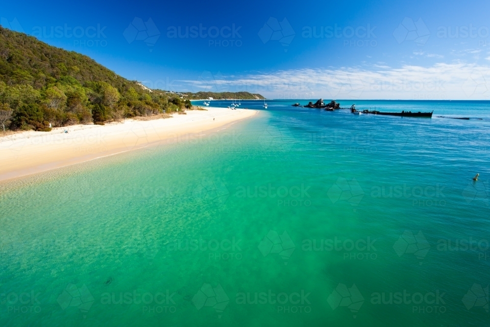 The Wrecks at Moreton Island settled in the clear blue green waters of Moreton Bay. - Australian Stock Image