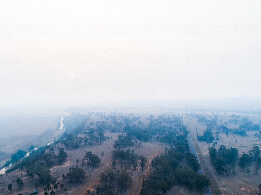 Thick smoke haze over farmland in hunter valley from bushfires - Australian Stock Image