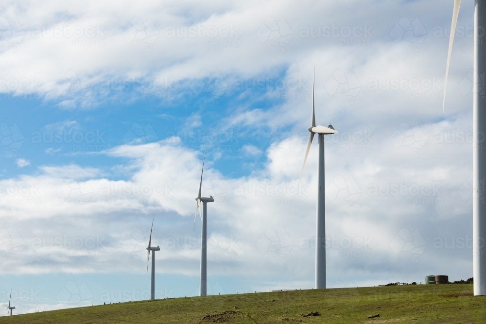 Three wind turbines on a bare grassy hill in the Fleurieu Peninsula. - Australian Stock Image