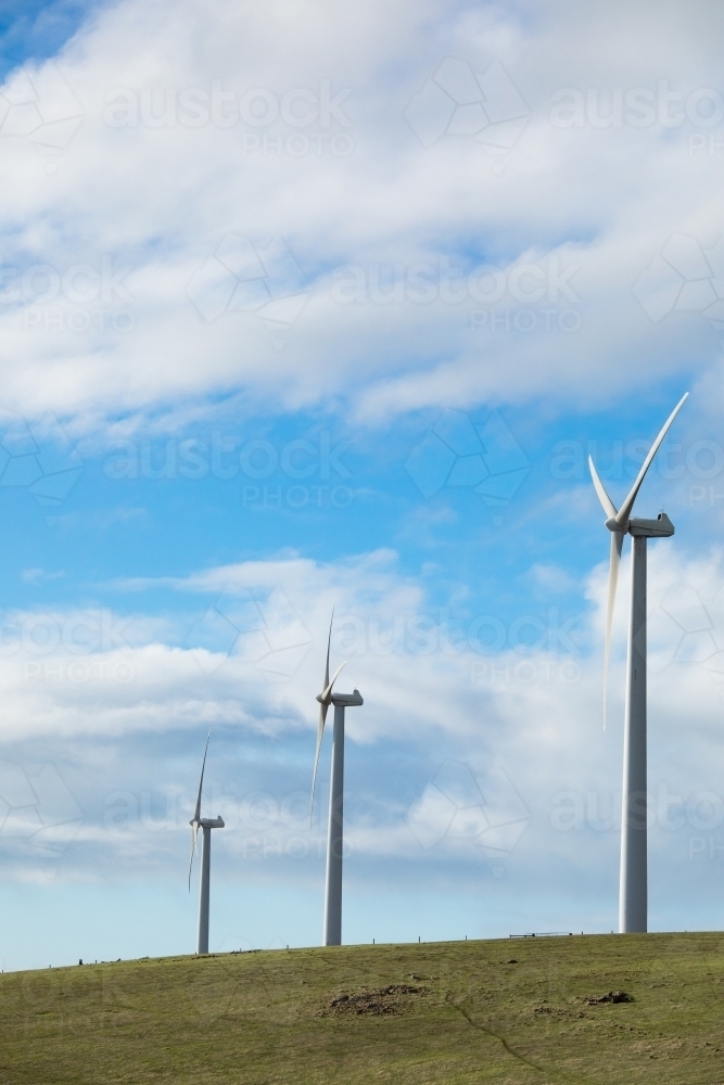 Three wind turbines on a bare grassy hill in the Fleurieu Peninsula. - Australian Stock Image