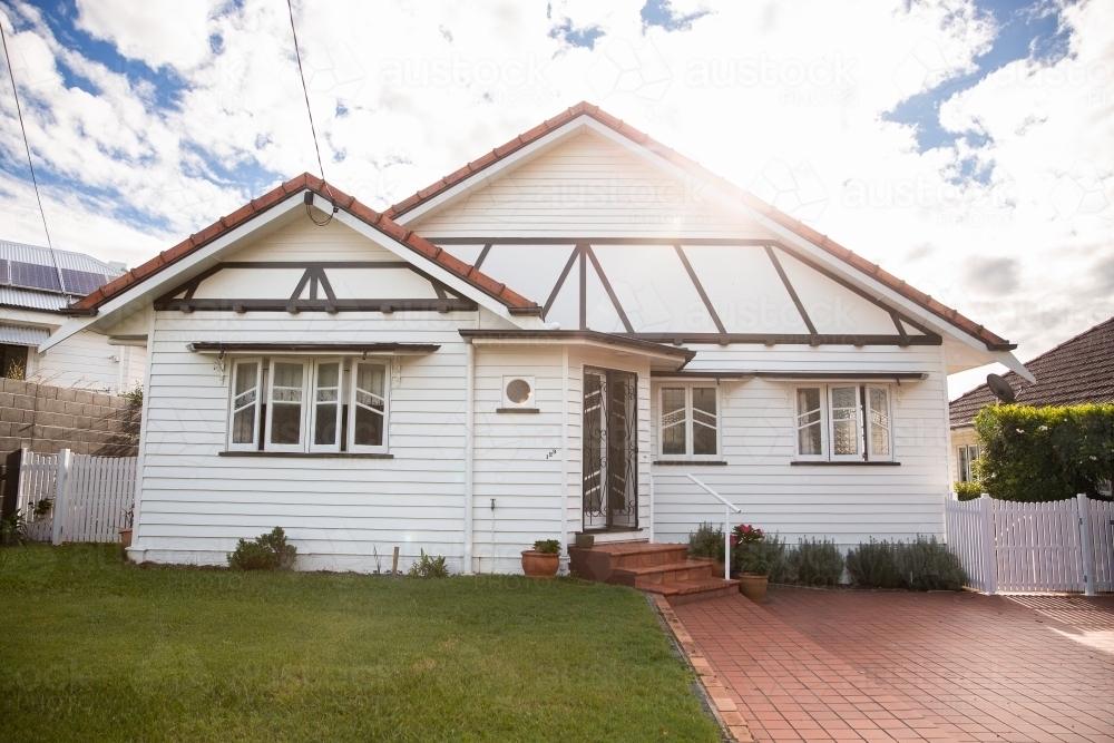 tidy white timber home on a sunny day in suburban Brisbane - Australian Stock Image