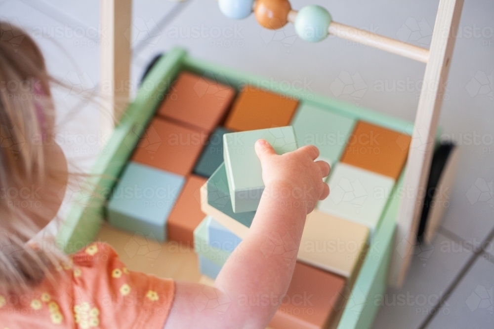 Toddler building block tower in push trolley - Australian Stock Image