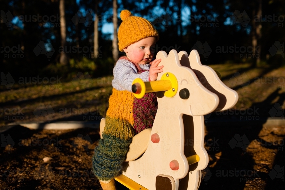 Toddler riding playground kangaroo - Australian Stock Image