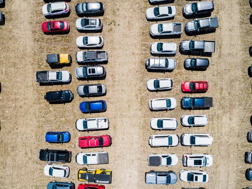 Top down aerial photo of cars in overflow parking in paddock during sport event - Australian Stock Image