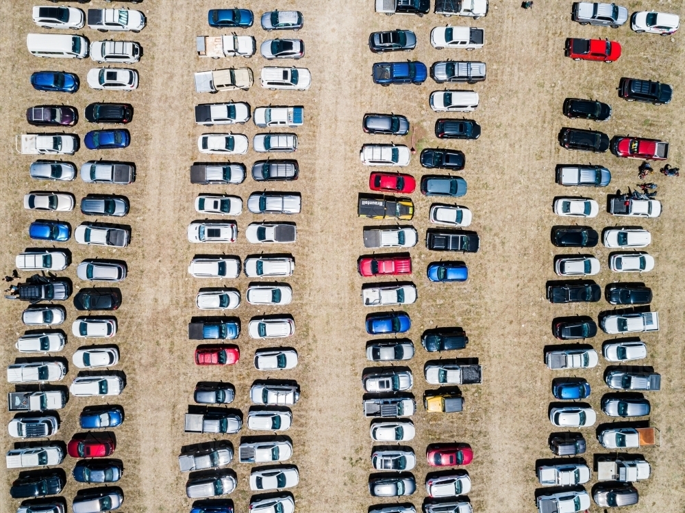 Top down aerial photo of cars in overflow parking in paddock during sport event - Australian Stock Image