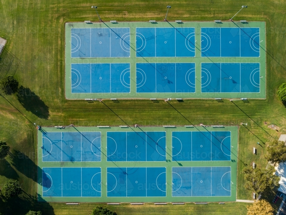 Top down overhead aerial view of netball courts side by side in park - Australian Stock Image