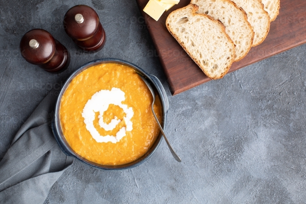 top down scene of pumpkin soup and sourdough bread - Australian Stock Image