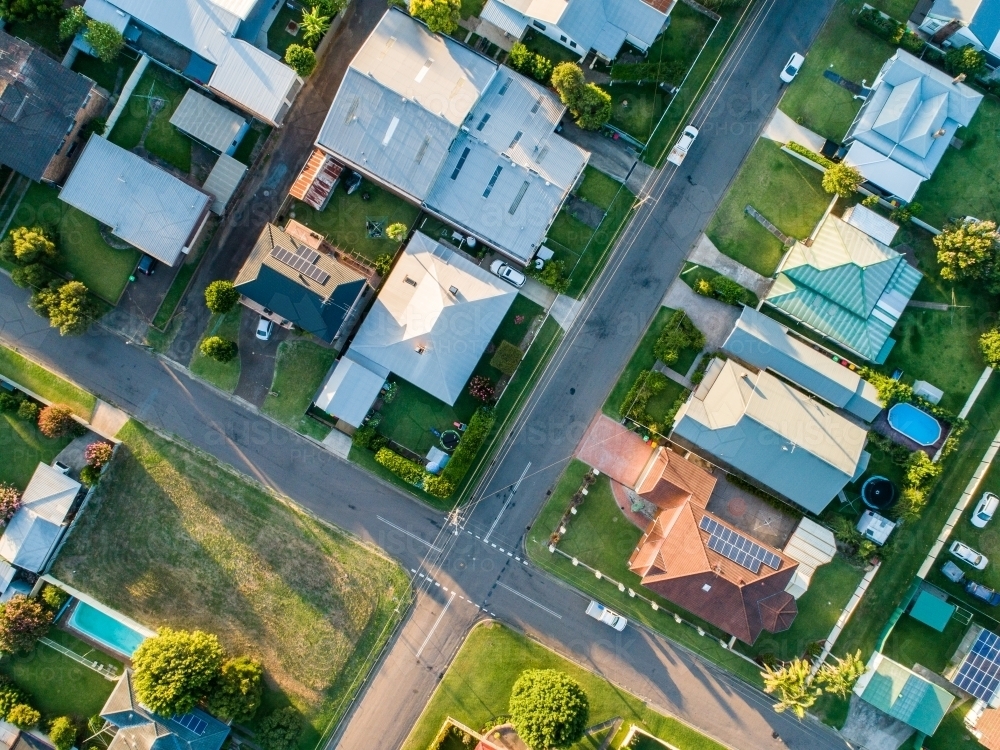 Image of Top down view of intersection with houses and empty lot in