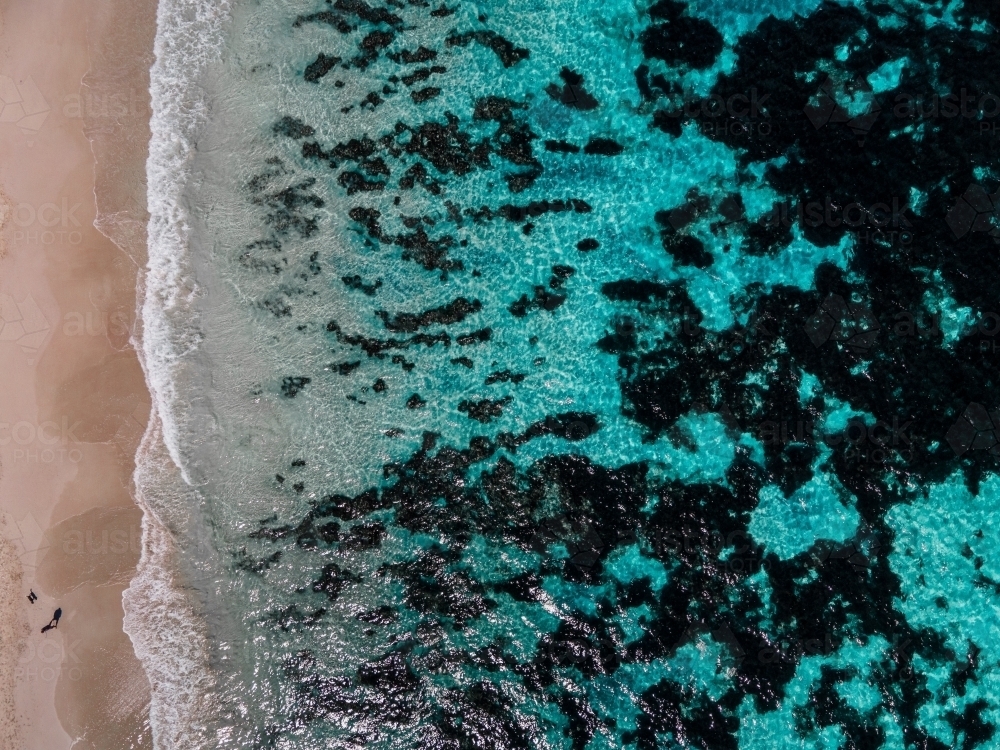 top shot of a beach with waves and seaweeds on a sunny day - Australian Stock Image