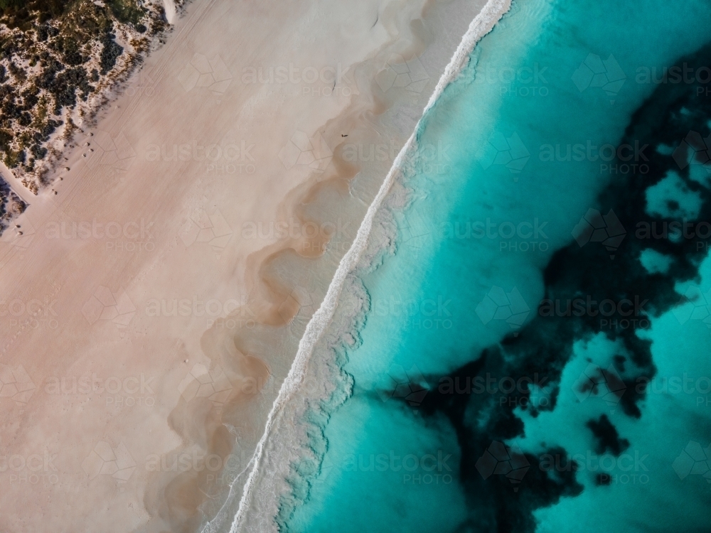 top shot of Summers in Perth with white sand, green grass and ocean water - Australian Stock Image