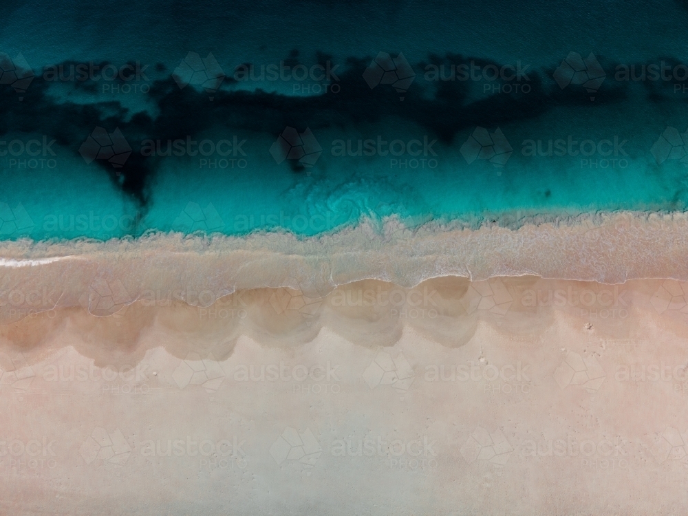 top shot of Summers in Perth with white sand, waves and ocean water - Australian Stock Image