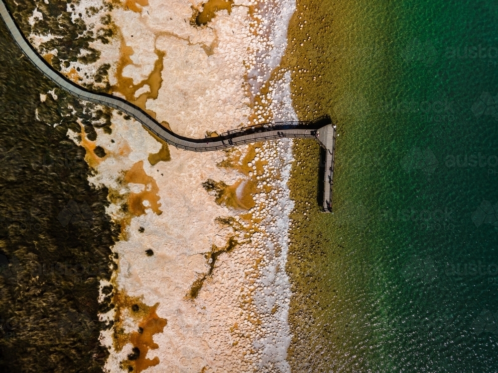 top view shot of a beach walkway with bushes and trees on a sunny day - Australian Stock Image