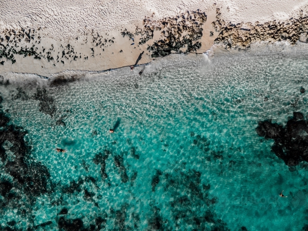 top view shot of a beach with clear waters, seaweeds and small waves - Australian Stock Image