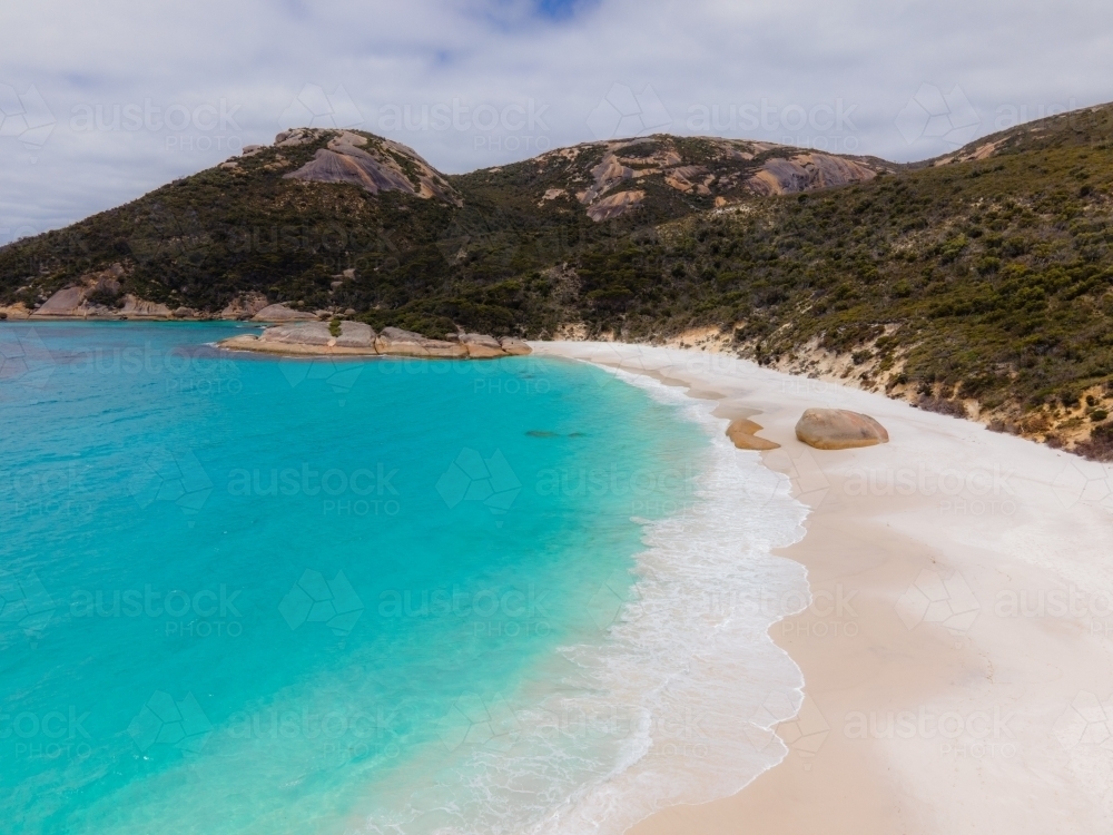 Top view shot of a beach with white shore and mountains - Australian Stock Image