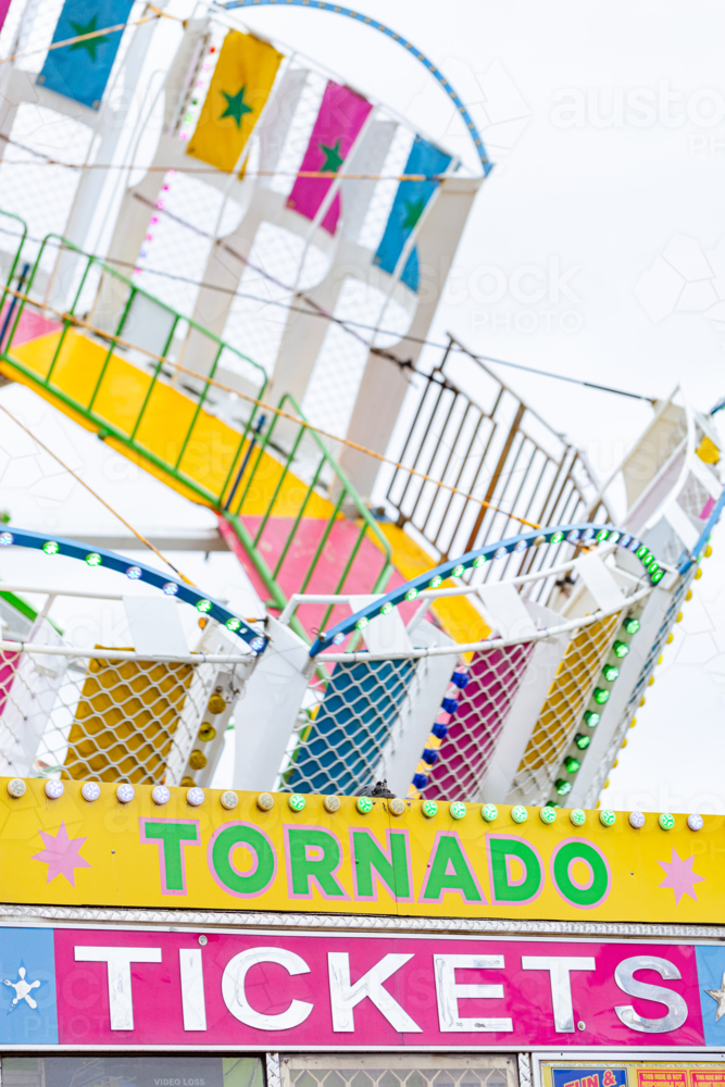 Tornado fun fair carnival ride at show with ticket booth sign - Australian Stock Image