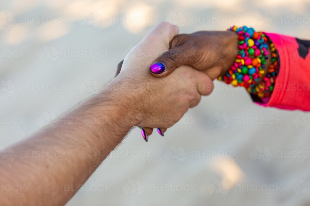 Torres Strait Islander woman shaking hands with Caucasian man - Australian Stock Image