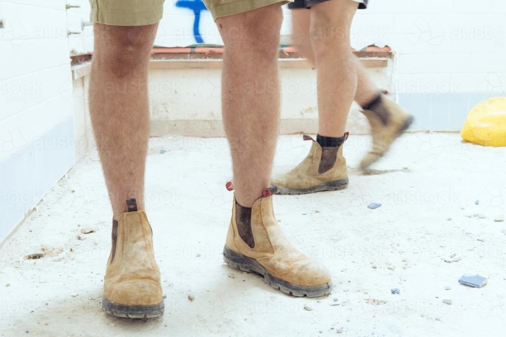 Tradesman wearing boots on construction site - Australian Stock Image