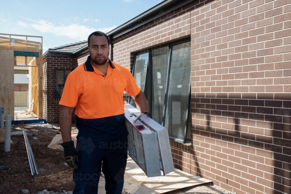 Image of Tradie at work on building site - Austockphoto