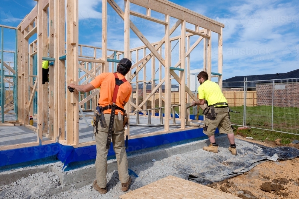 Image of Tradie working on house building site - Austockphoto