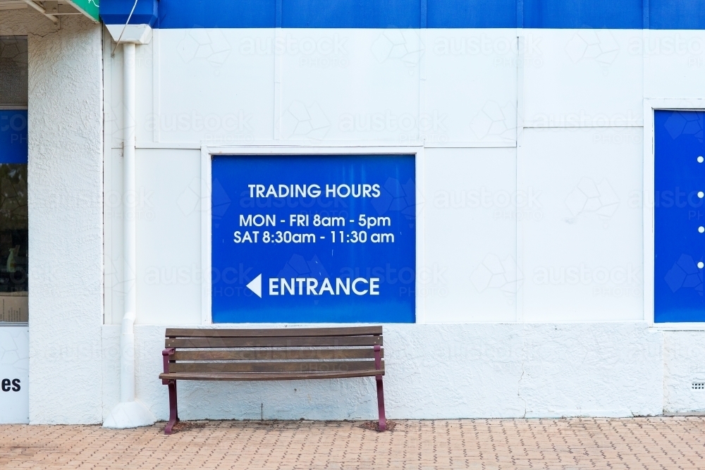 Image of Trading hours signage and seat outside country store