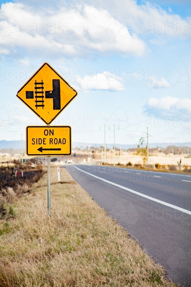 Train track crossing on side road sign on rural road - Australian Stock Image