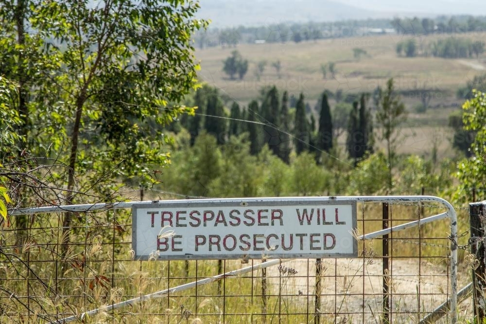 Trespasser will be prosecuted sign on a paddock gate - Australian Stock Image