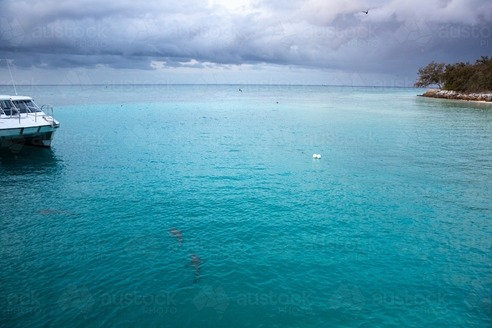 tropical storms rolling in over the clear blue waters of Heron Island - Australian Stock Image