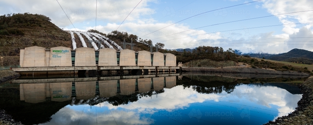 Tumut 3 power station reflected in water, part of the snowy hydro electric scheme - Australian Stock Image