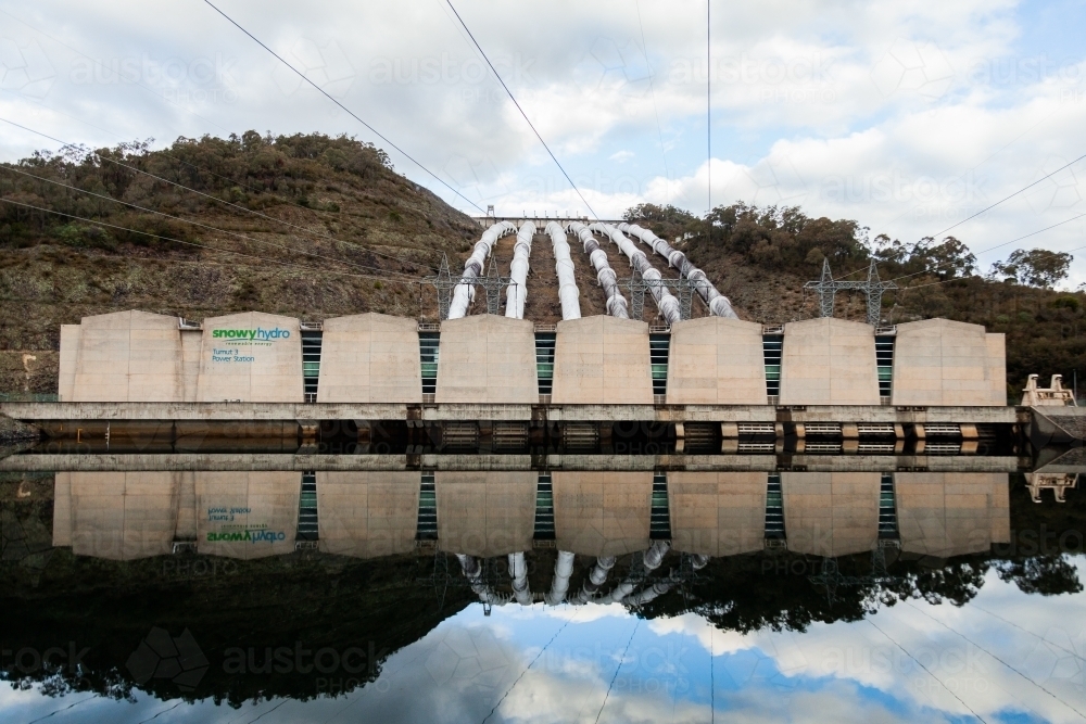 Tumut 3 power station reflected in water, part of the snowy hydro electric scheme - Australian Stock Image