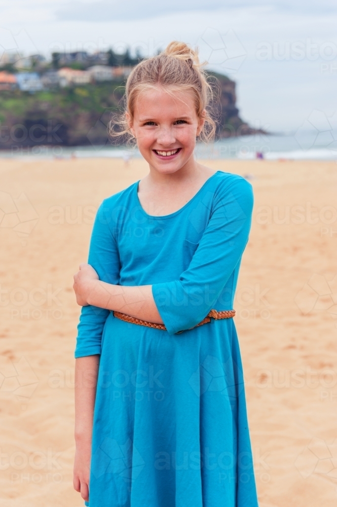 tween girl at beach in blue dress - Australian Stock Image