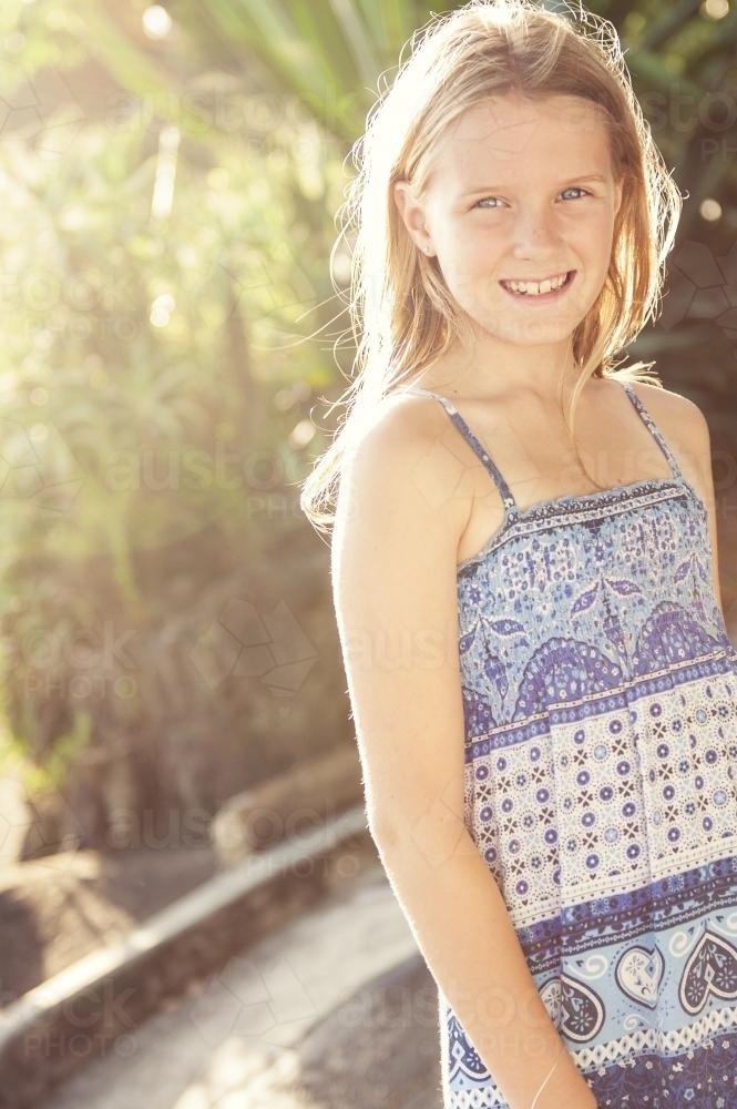 tween girl in blue summer dress - Australian Stock Image