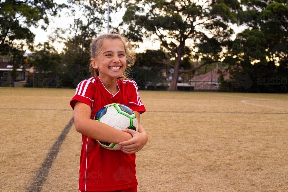Tween soccer player laughing with copy space - Australian Stock Image