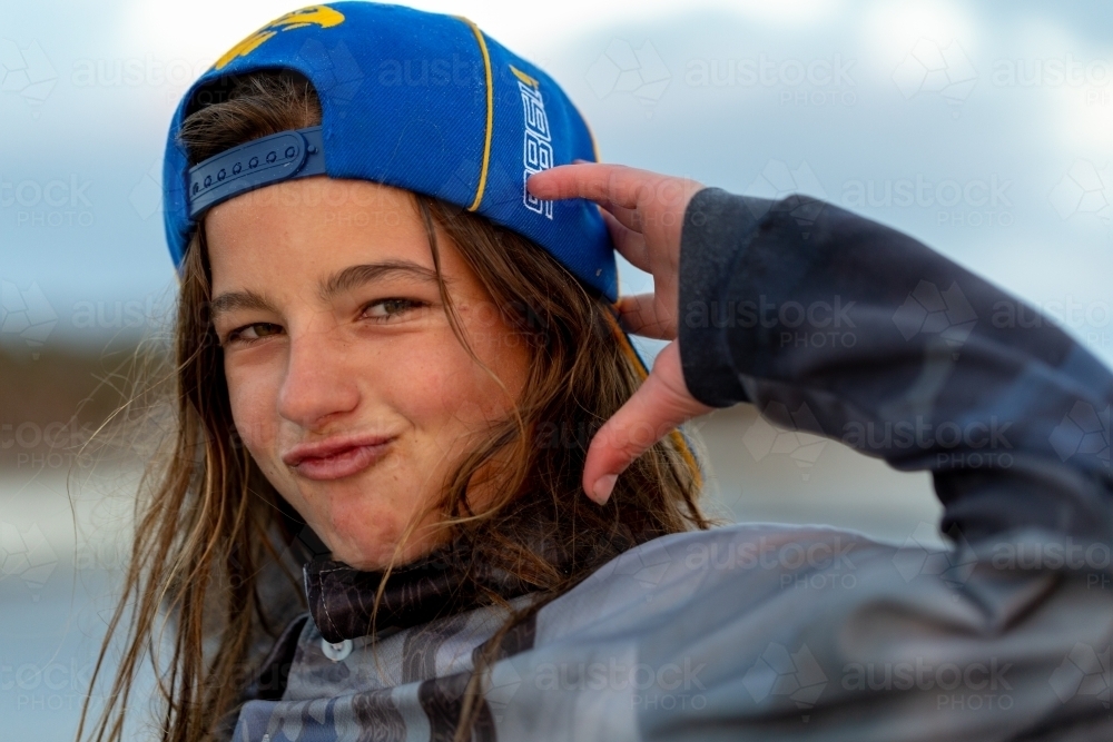 Tween with attitude and baseball cap on backwards - Australian Stock Image