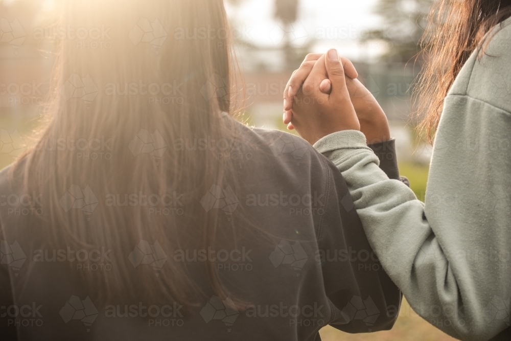 Two Aboriginal girls holding hands - Australian Stock Image