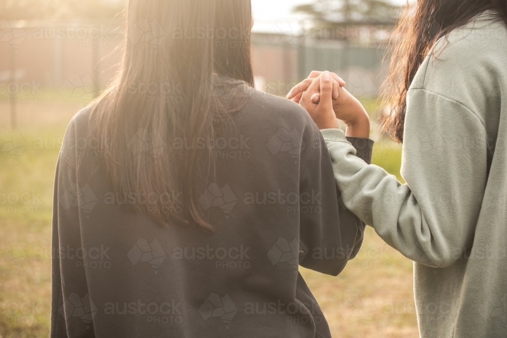 Two Aboriginal girls holding hands - Australian Stock Image