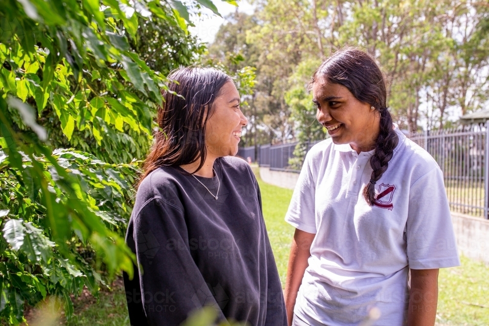 Two Aboriginal girls talking outside - Australian Stock Image