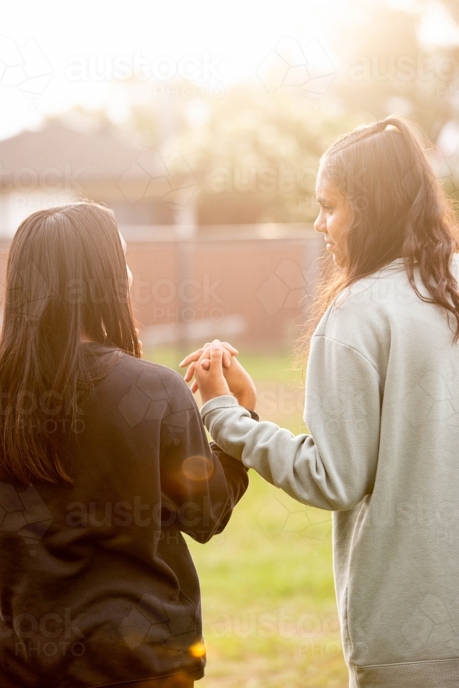 Two Aboriginal young women walking together - Australian Stock Image