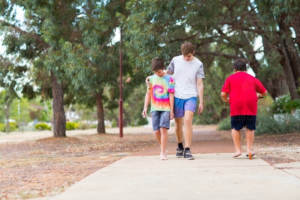 Two boys walking along a path - Australian Stock Image