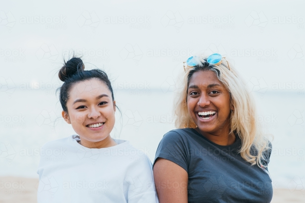 two friends at the beach at dusk - Australian Stock Image