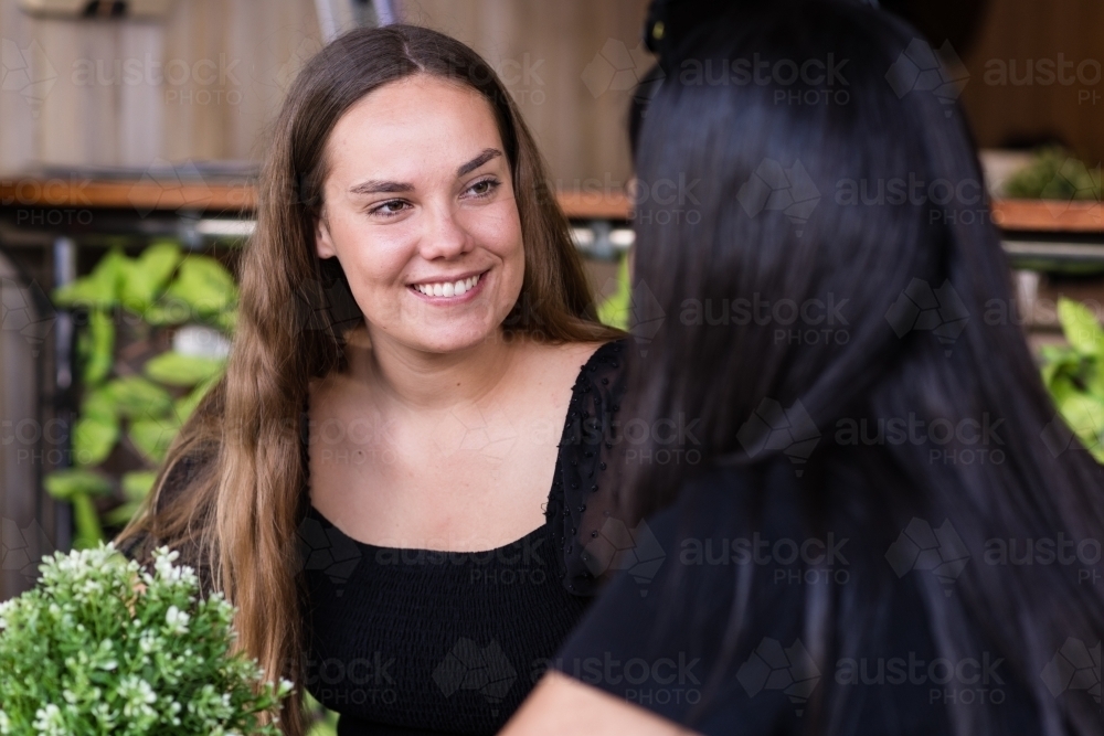 two friends chatting in a cafe - Australian Stock Image