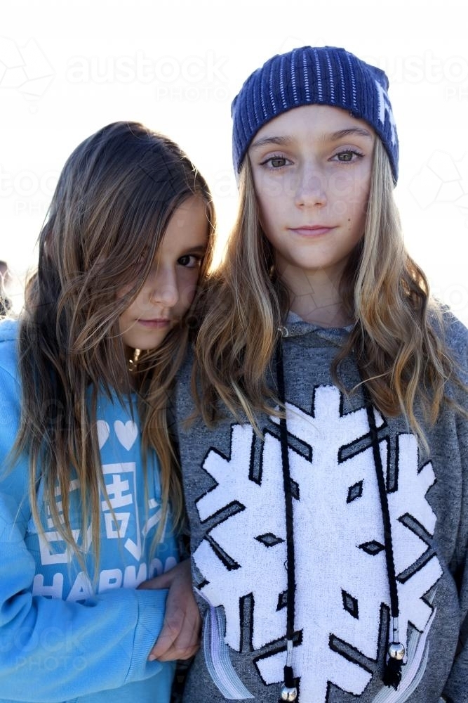 Image Of Two Girls Standing Next To Each Other Looking Serious Austockphoto