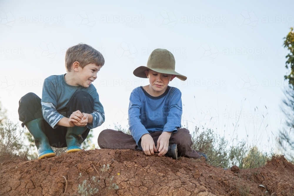 Two happy Aussie kids playing outdoors in natural setting - Australian Stock Image