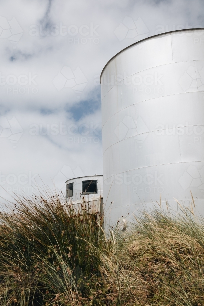 Two large, cylindrical storage tanks with a flat top. - Australian Stock Image