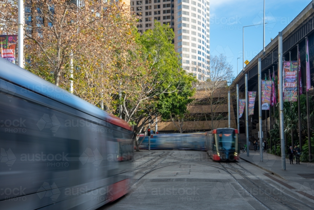 Two light rail trains in Sydney at Circular Quay shot with a long exposure - Australian Stock Image